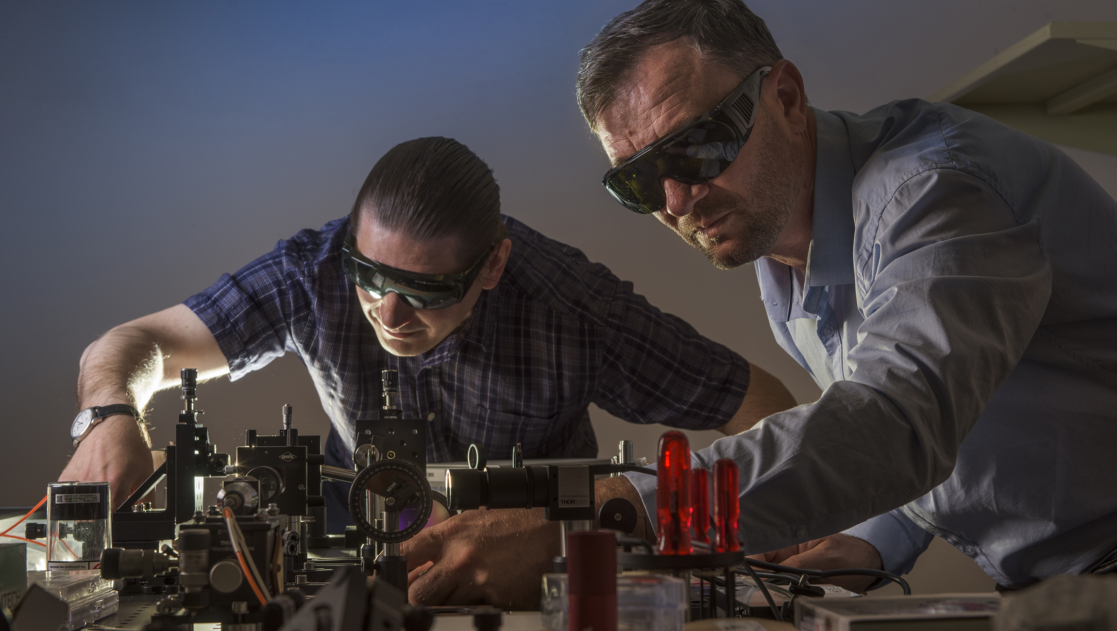 Professor Andrey Miroshnichenko, from UNSW Canberra, and Dr Vladlen Shvedov from the Australian National University photographed in a laser lab at UNSW Canberra.