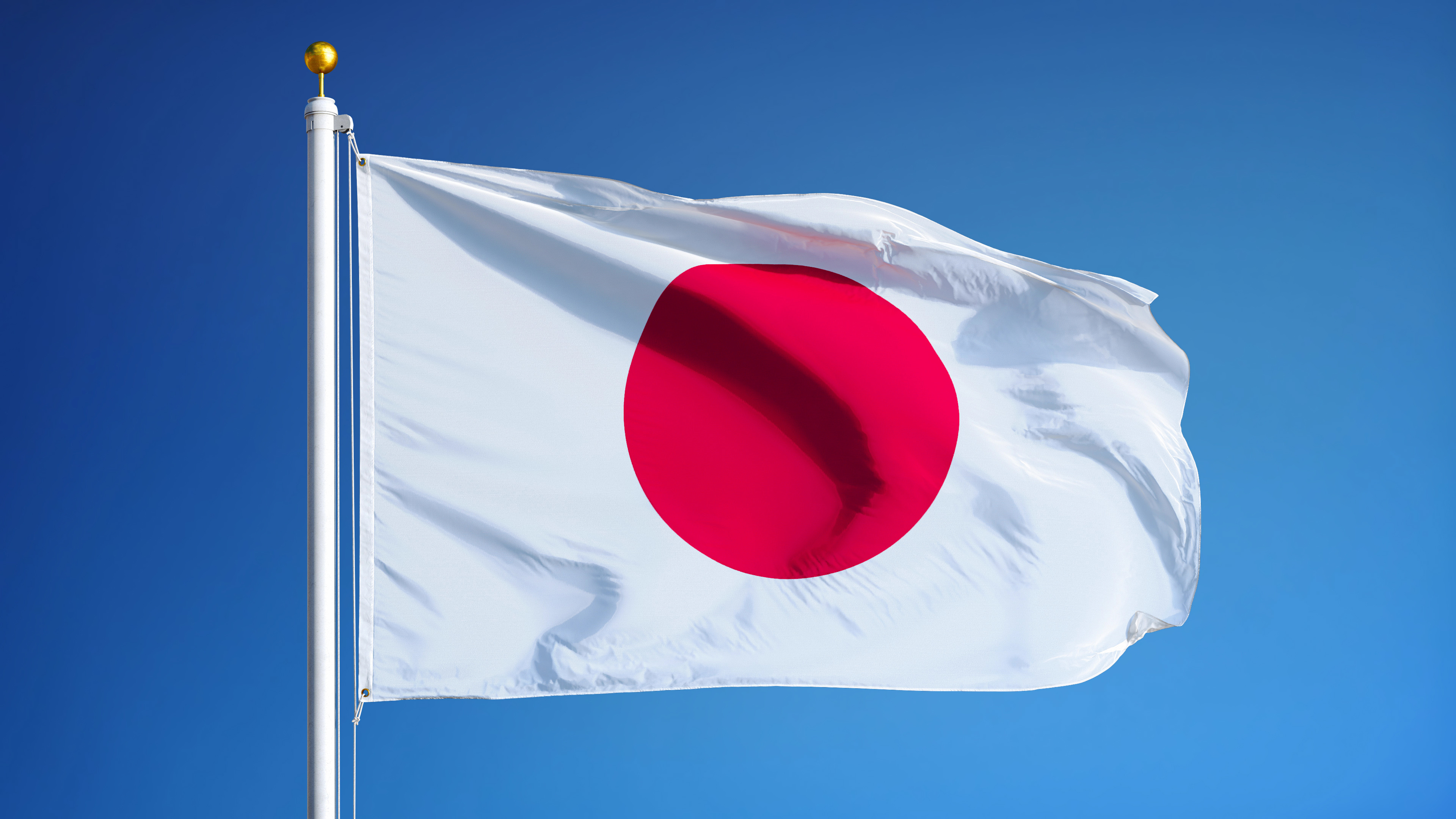 Japanese flag against blue sky background