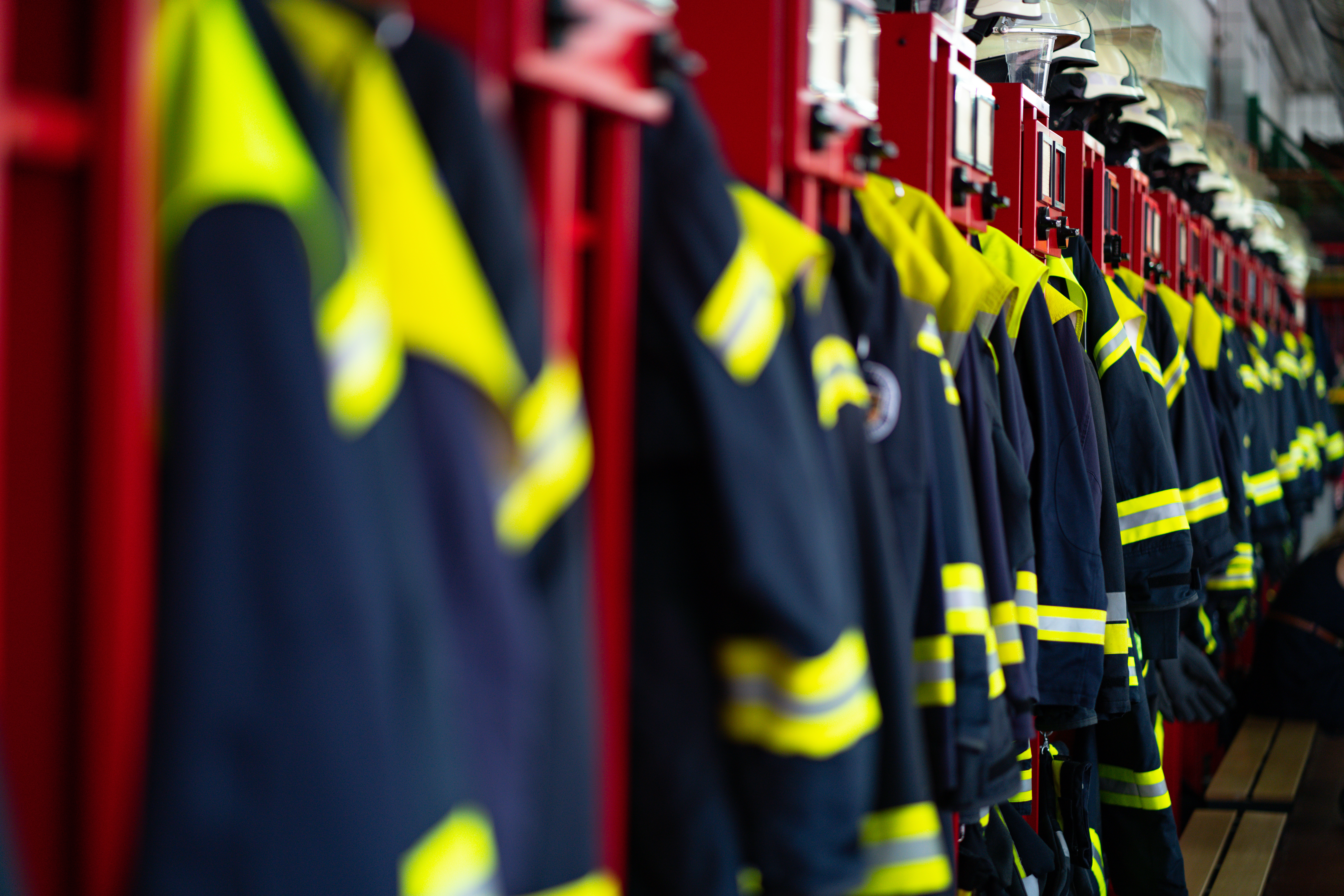 Firefighters&#039; suits lined up in a firestation. 