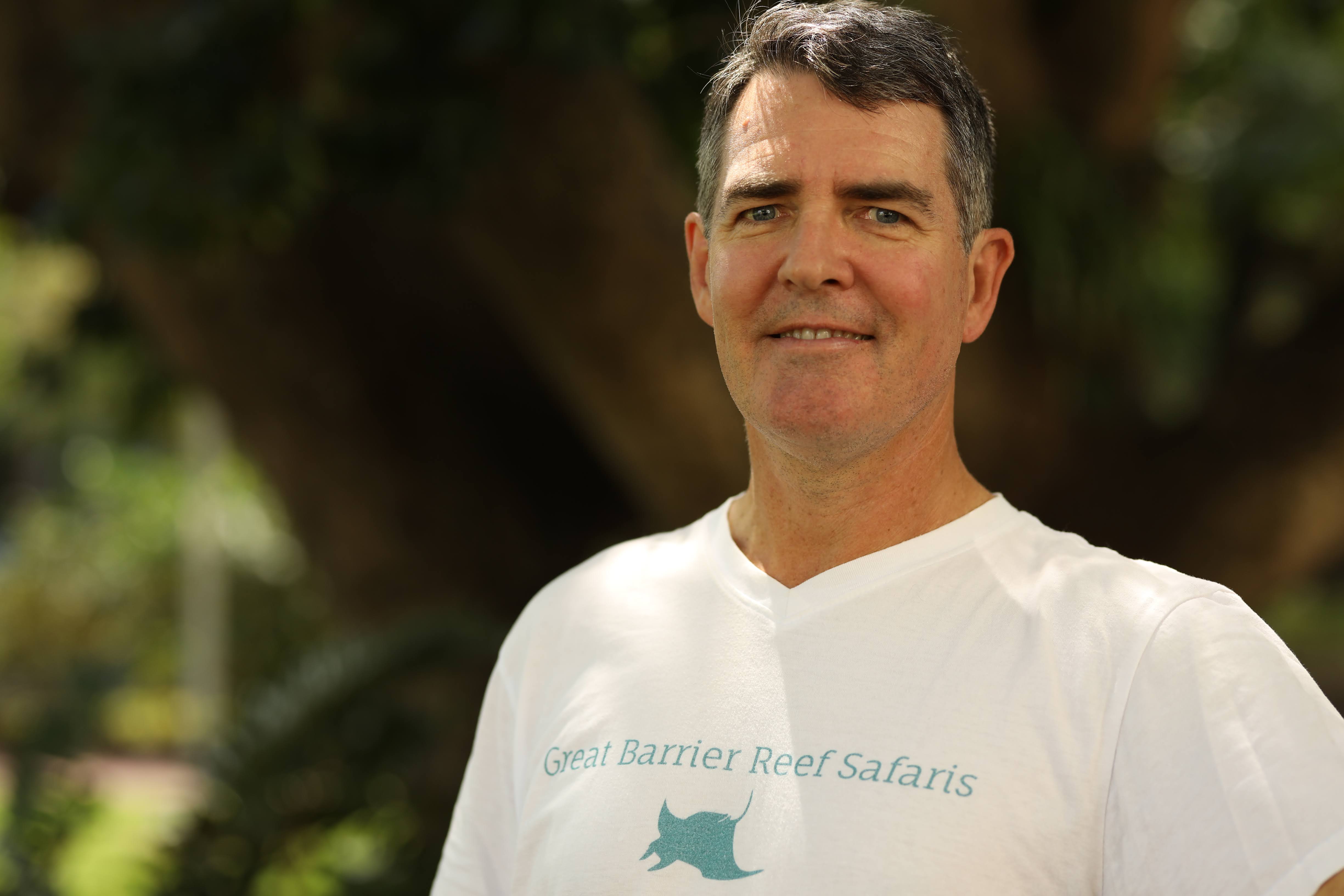 Stuart alexander wearing a t-shirt with &quot;Great Barrier Reef Safaris&quot; 
