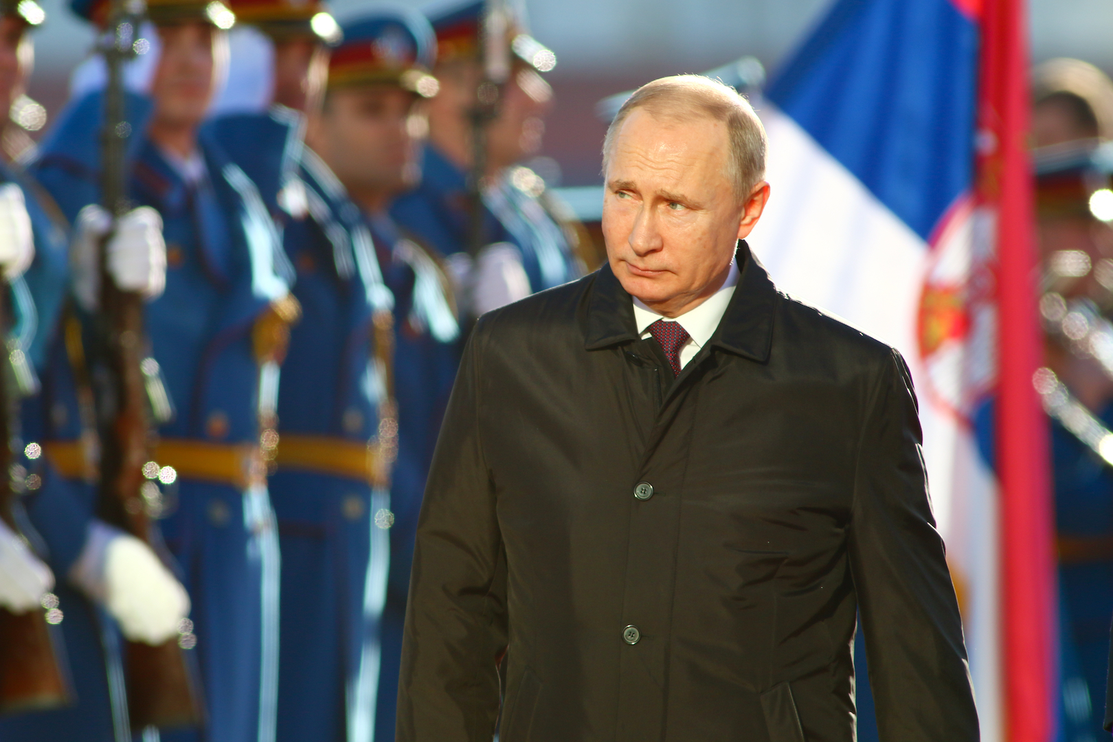 Vladimir Putin inspects parading troops.