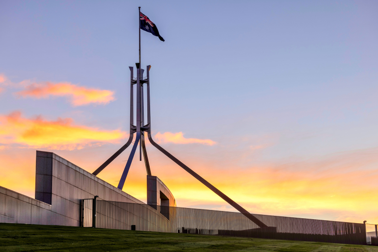 Australian Parliament House Canberra Australian Capital Territory. Showing the roof at sunset and the Australian Flag