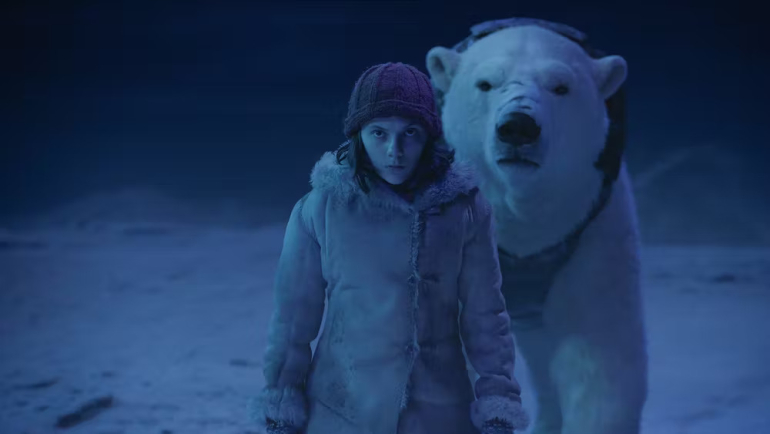 Woman stands with polar bear behind her