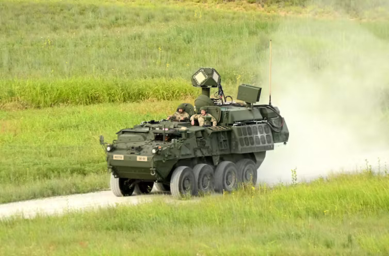 Armoured vehicle in a field with laser system mounted on top