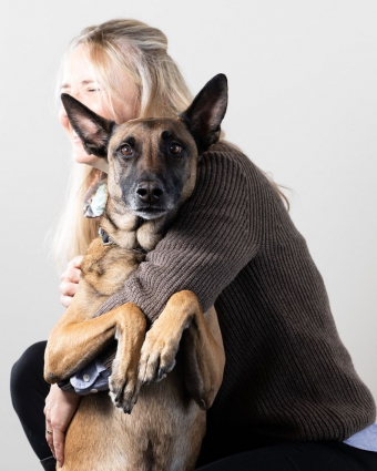 Woman poses with a dog