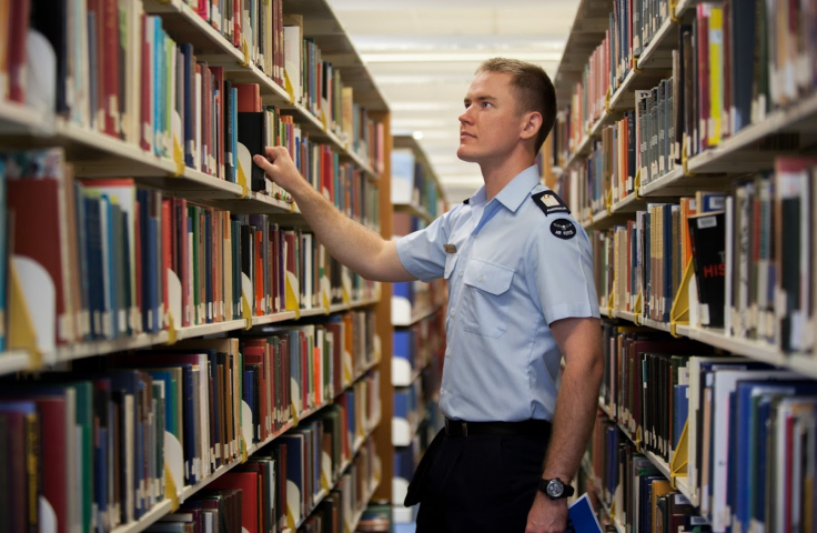 Cadet looking at books in the Academy Library