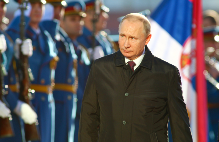 Vladimir Putin inspects parading troops.